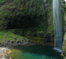 Waterfall spilling into a pool at the end of Hanakapi'ai trail